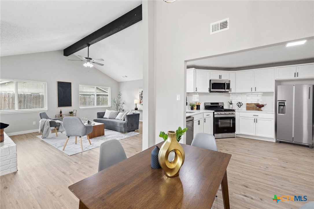 804 Antelope Trail Temple, TX 76504 - Photo 11 of 32 a living room with kitchen island furniture and a kitchen view