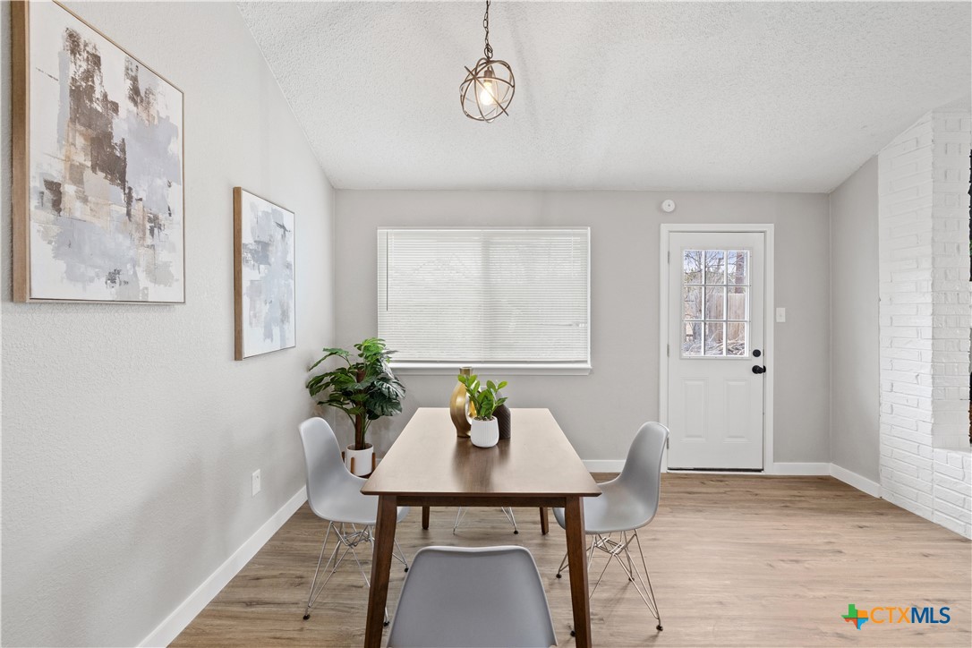 804 Antelope Trail Temple, TX 76504 - Photo 13 of 32 a view of a dining room with furniture and wooden floor