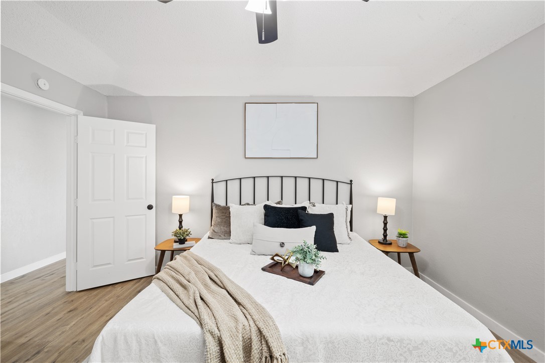 804 Antelope Trail Temple, TX 76504 - Photo 17 of 32 a bedroom with a bed and wooden floor