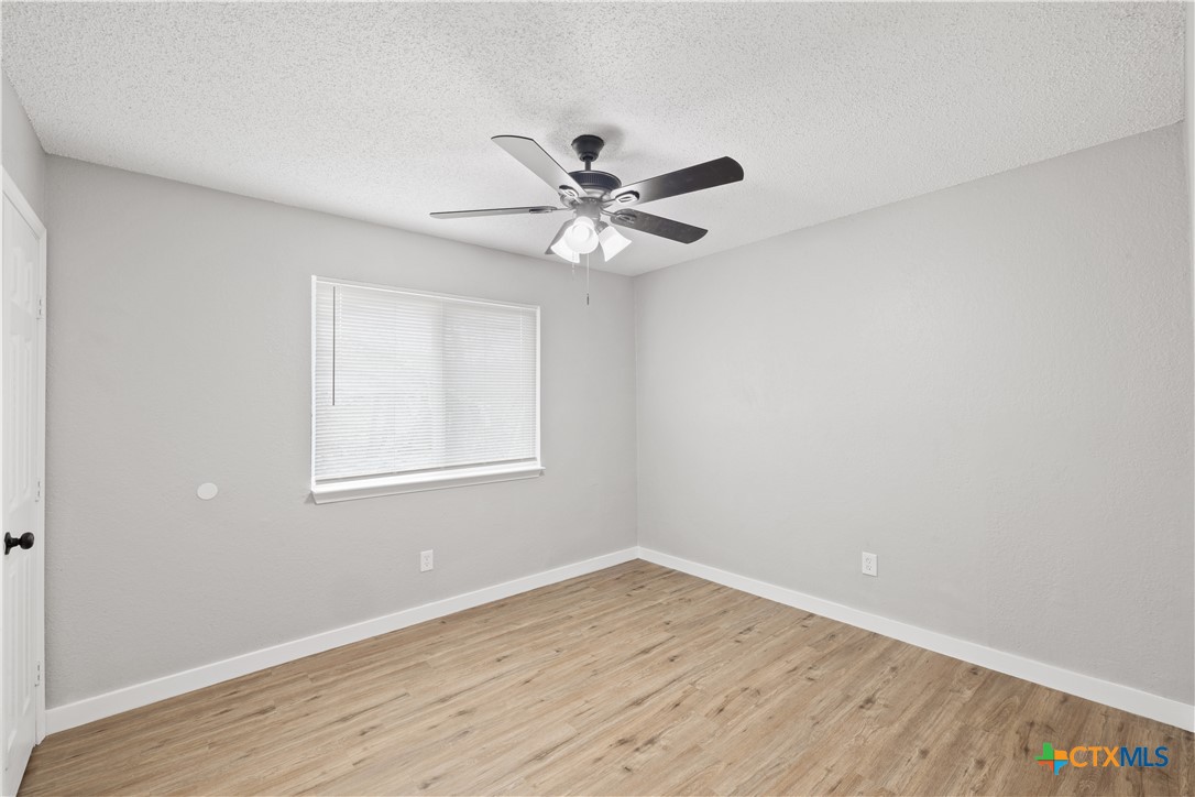 804 Antelope Trail Temple, TX 76504 - Photo 23 of 32 wooden floor in an empty room with a window