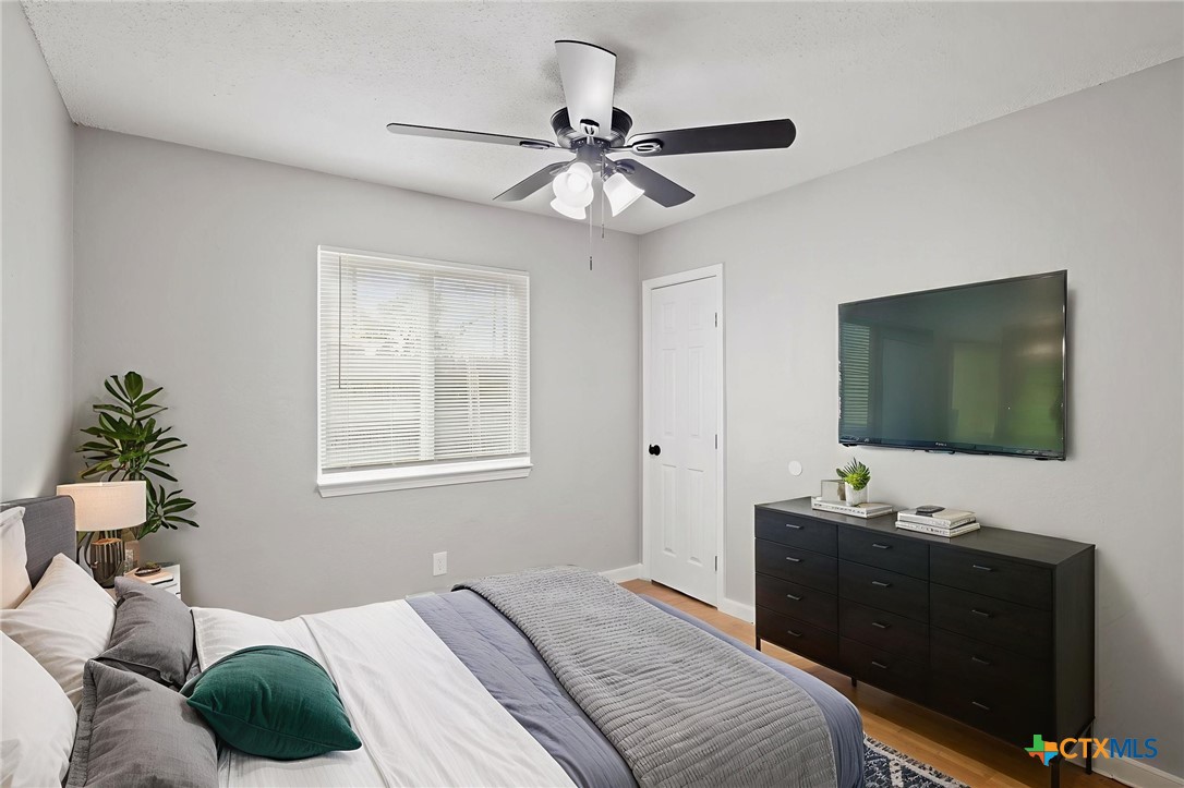 804 Antelope Trail Temple, TX 76504 - Photo 25 of 32 a bedroom with a bed and a flat screen tv