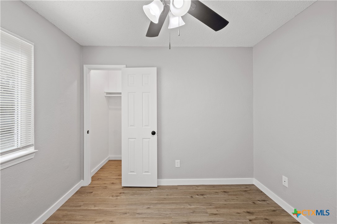 804 Antelope Trail Temple, TX 76504 - Photo 27 of 32 a view of an empty room with wooden floor and a window