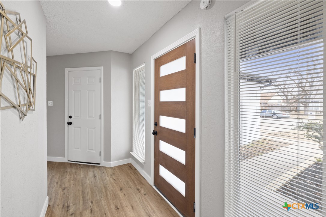 804 Antelope Trail Temple, TX 76504 - Photo 4 of 32 a view of a room with wooden floor and windows