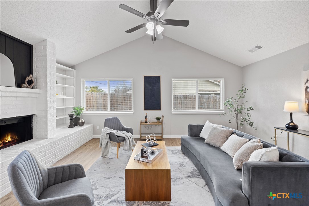 804 Antelope Trail Temple, TX 76504 - Photo 6 of 32 a living room with furniture a fireplace and a large window