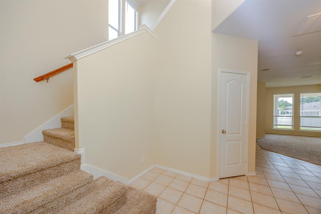 1828 Mercer Way Savannah, TX 76227 - Photo 10 of 38 Staircase featuring healthy amount of natural light, carpet floors, and tile patterned floors