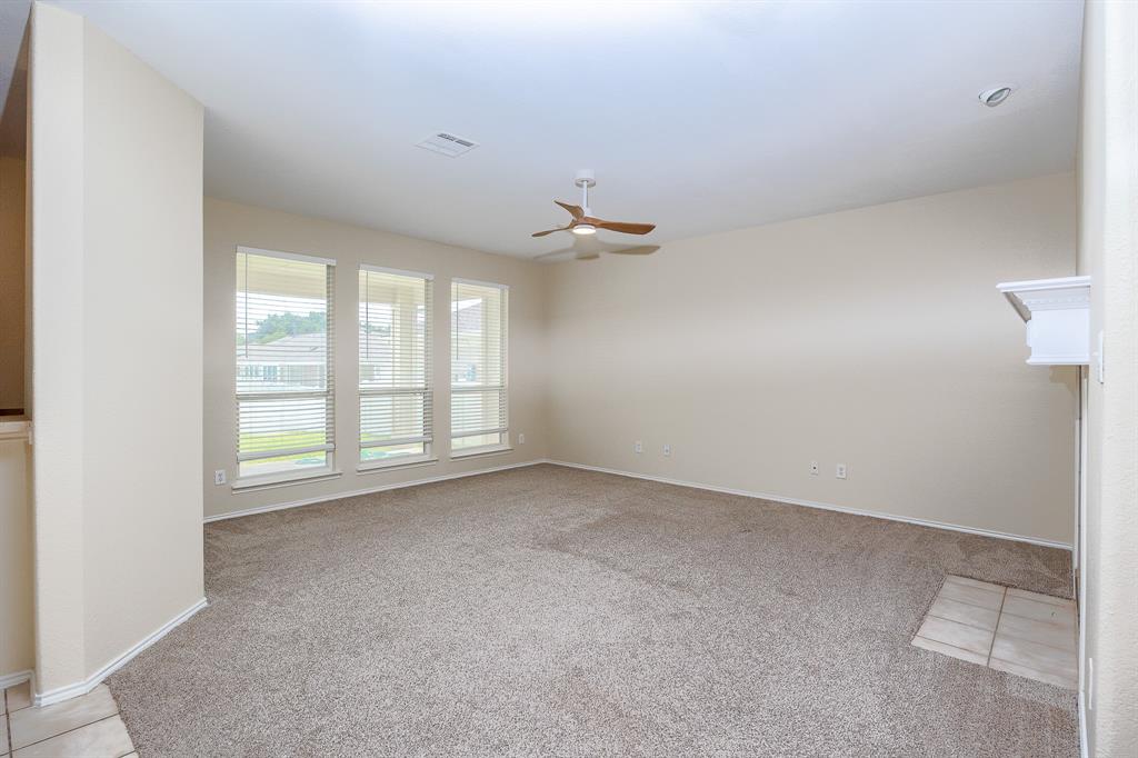 1828 Mercer Way Savannah, TX 76227 - Photo 11 of 38 Empty room with light carpet and ceiling fan