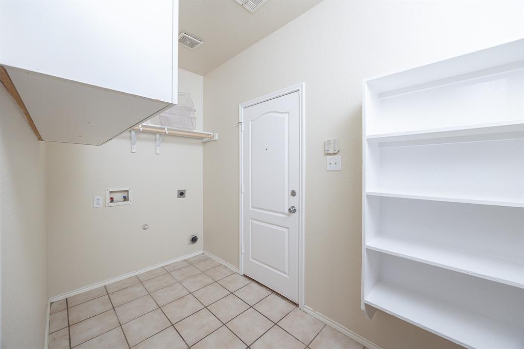 1828 Mercer Way Savannah, TX 76227 - Photo 15 of 38 Washroom featuring electric dryer hookup, hookup for a washing machine, light tile patterned floors, and hookup for a gas dryer