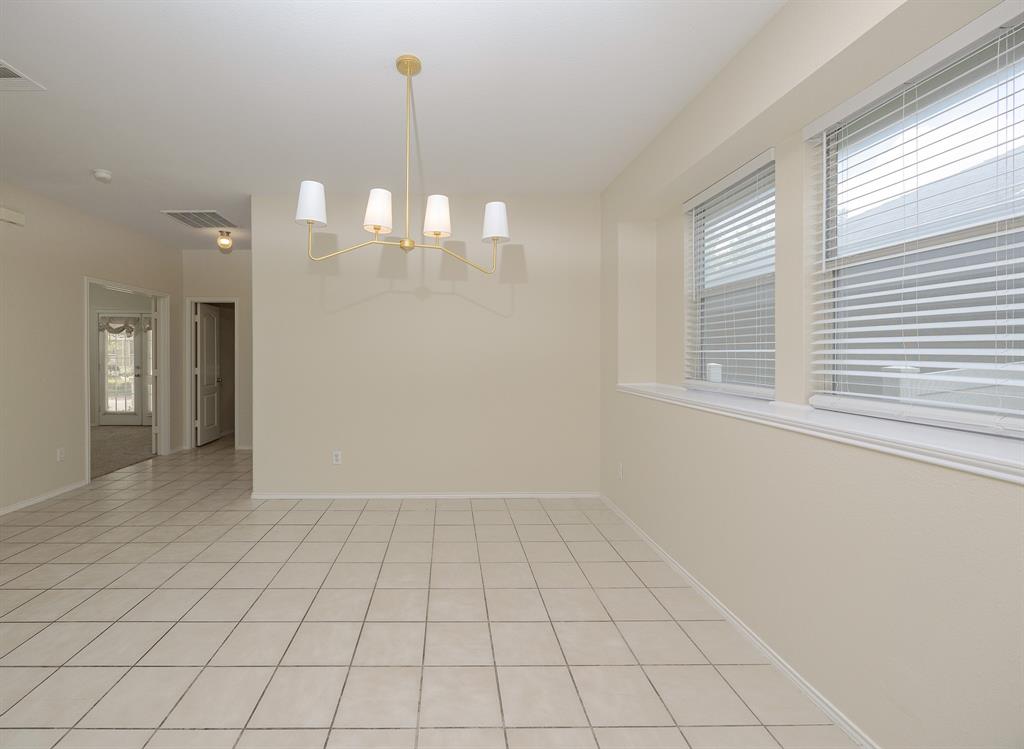1828 Mercer Way Savannah, TX 76227 - Photo 17 of 38 Spare room featuring light tile patterned flooring and a chandelier