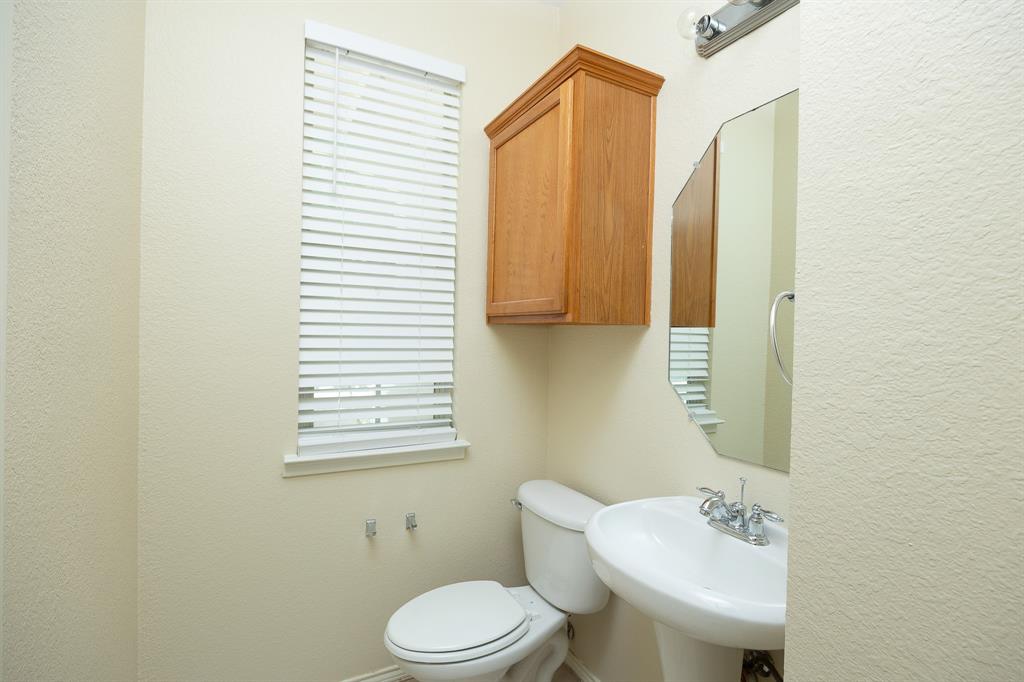 1828 Mercer Way Savannah, TX 76227 - Photo 9 of 38 Half bathroom featuring a textured wall and toilet