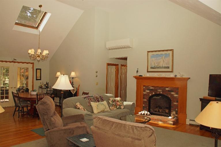 23 Dundee Circle Harwich, MA 02645 - Photo 5 of 23 a living room with furniture a fireplace and a flat screen tv