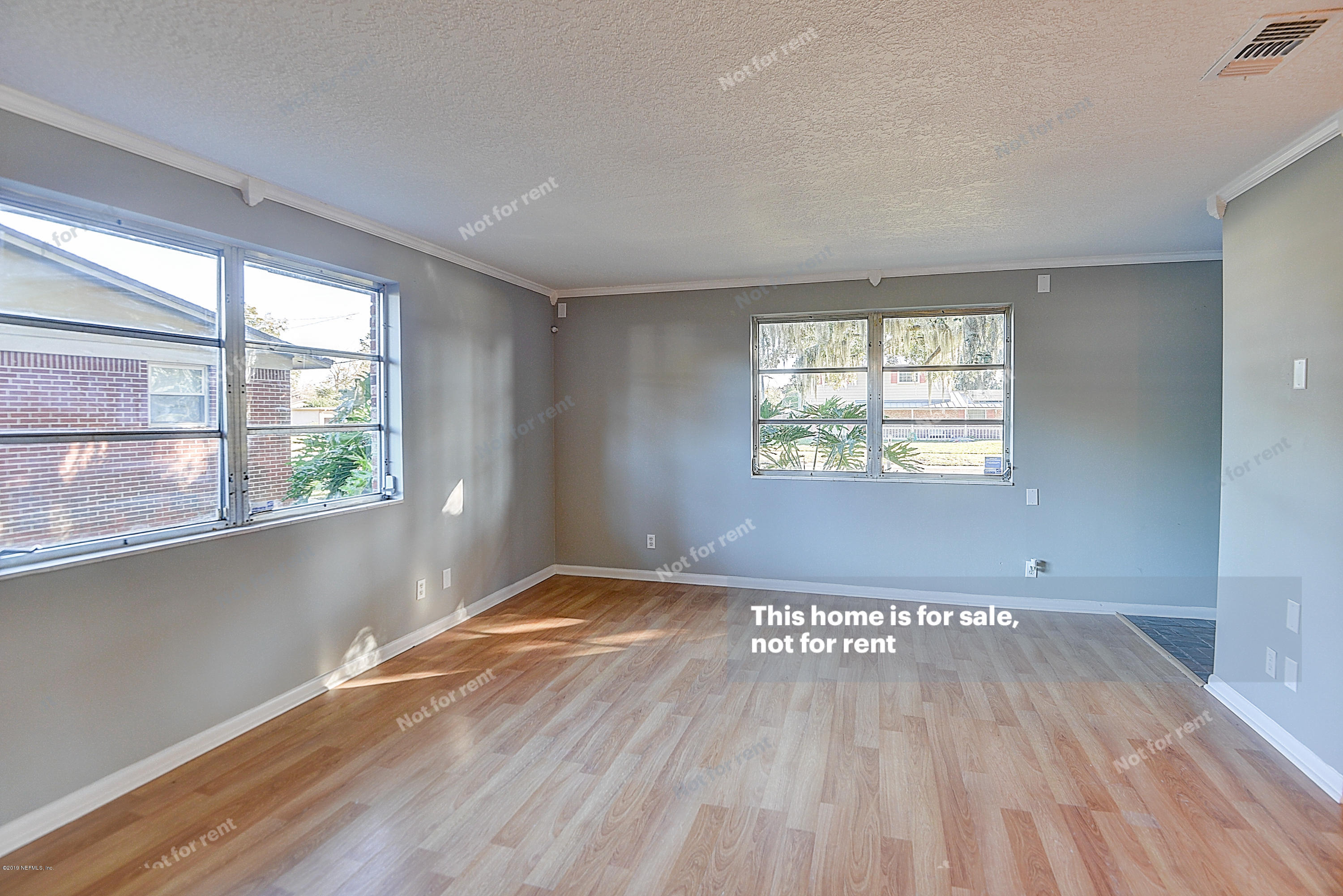 1152 Crown Drive Jacksonville, FL 32221 - Photo 2 of 31 an empty room with wooden floor and windows