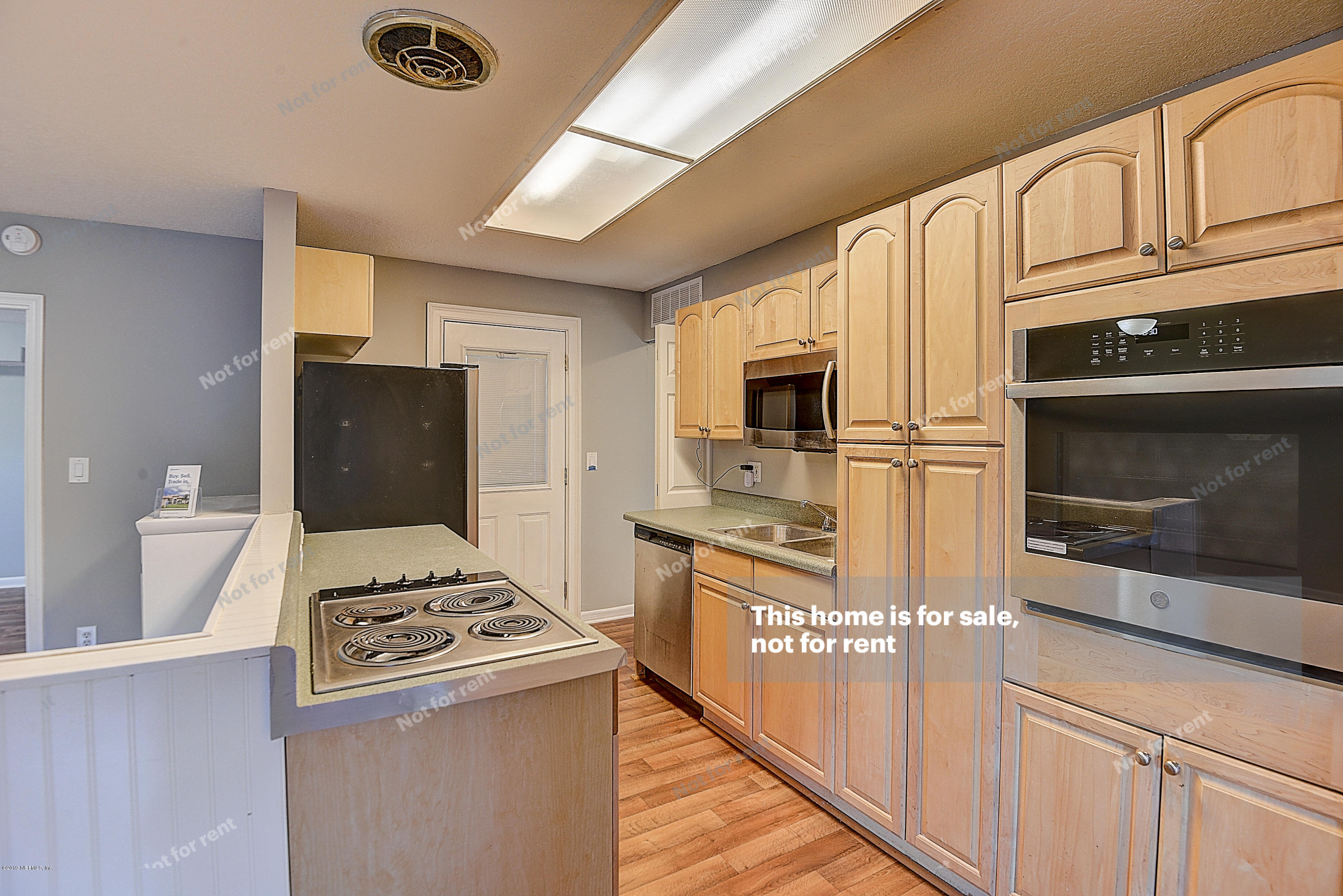 1152 Crown Drive Jacksonville, FL 32221 - Photo 3 of 31 a kitchen with stainless steel appliances a stove a microwave and a refrigerator