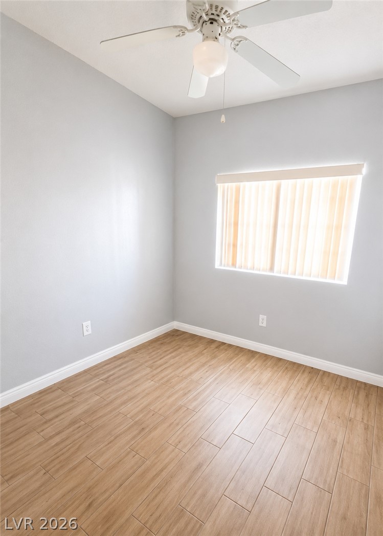 4730 East Craig Road, Unit 1163 Las Vegas, NV 89115 - Photo 5 of 6 Wood-look tile flooring and a ceiling fan provide both durability and comfort in this adaptable room.