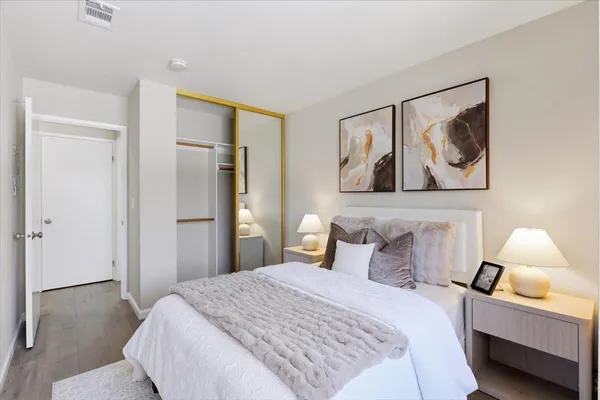 a bedroom with a bed and lamp