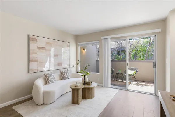 a living room with furniture and a potted plant