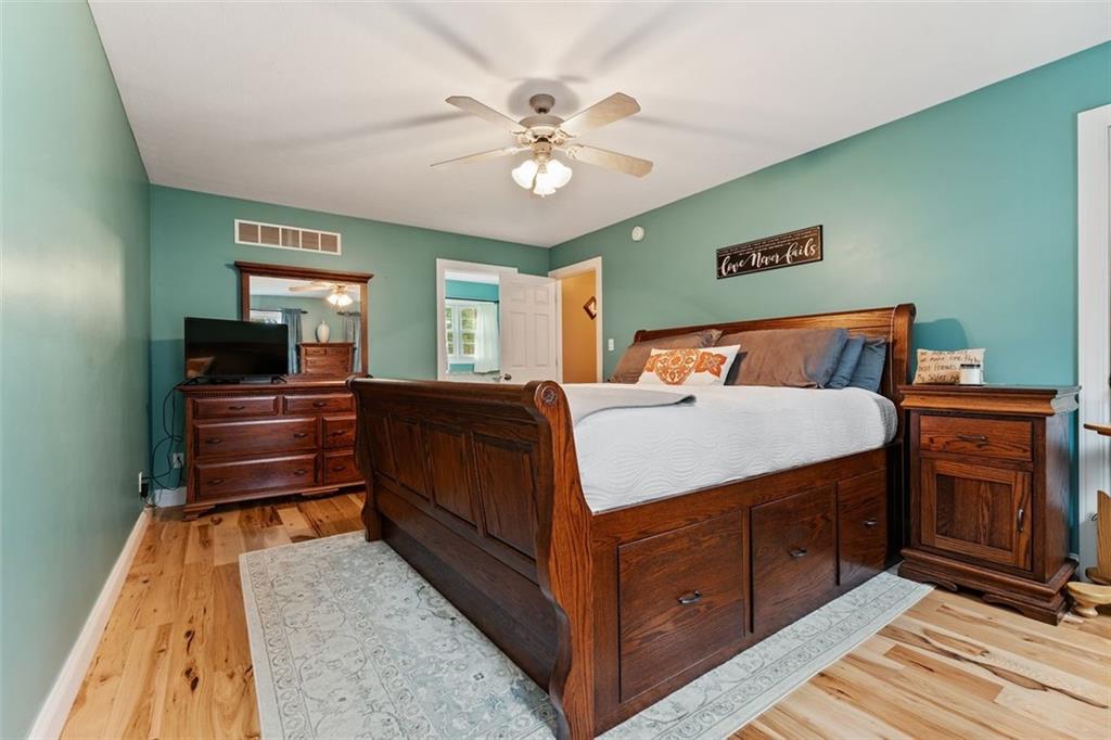 231 Smith Road Cabot, PA 16023 - Photo 14 of 25 a bedroom with a bed and wooden floor