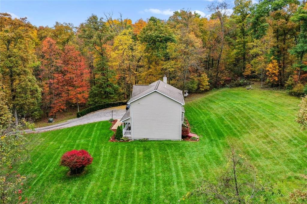 231 Smith Road Cabot, PA 16023 - Photo 22 of 25 a white house with a yard and garden