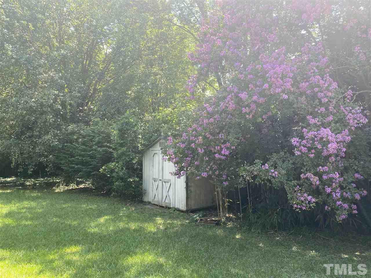 2604 Hiking Trail Raleigh, NC 27615 - Photo 2 of 12 a backyard of a house with lots of green space and fog