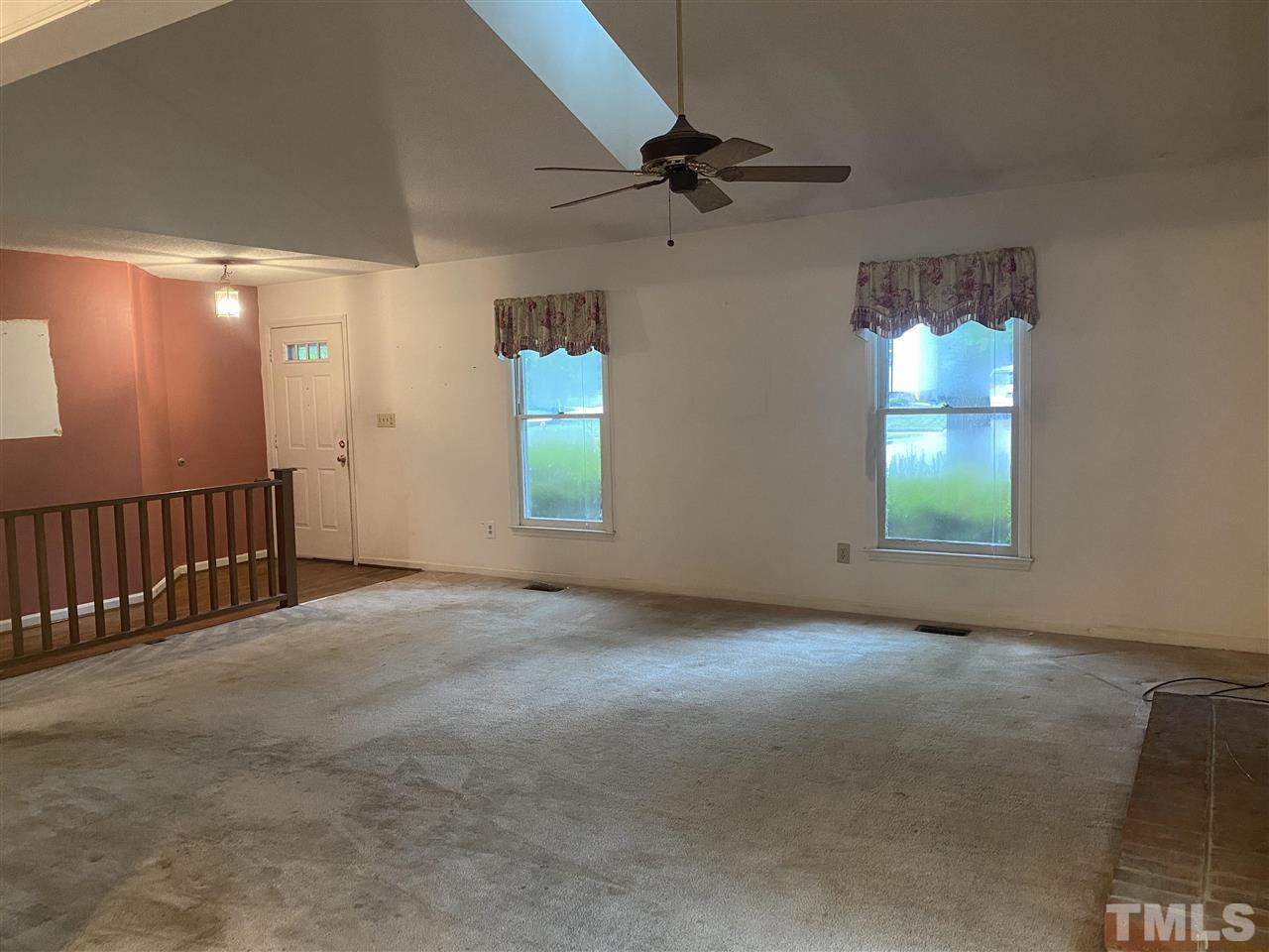 2604 Hiking Trail Raleigh, NC 27615 - Photo 11 of 12 en empty room with windows and ceiling fan