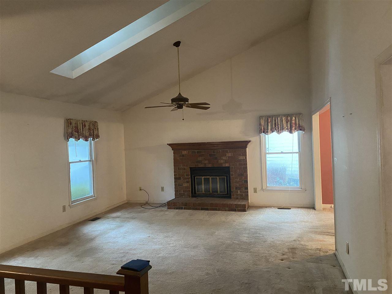 2604 Hiking Trail Raleigh, NC 27615 - Photo 12 of 12 a view of a livingroom with a fireplace and window