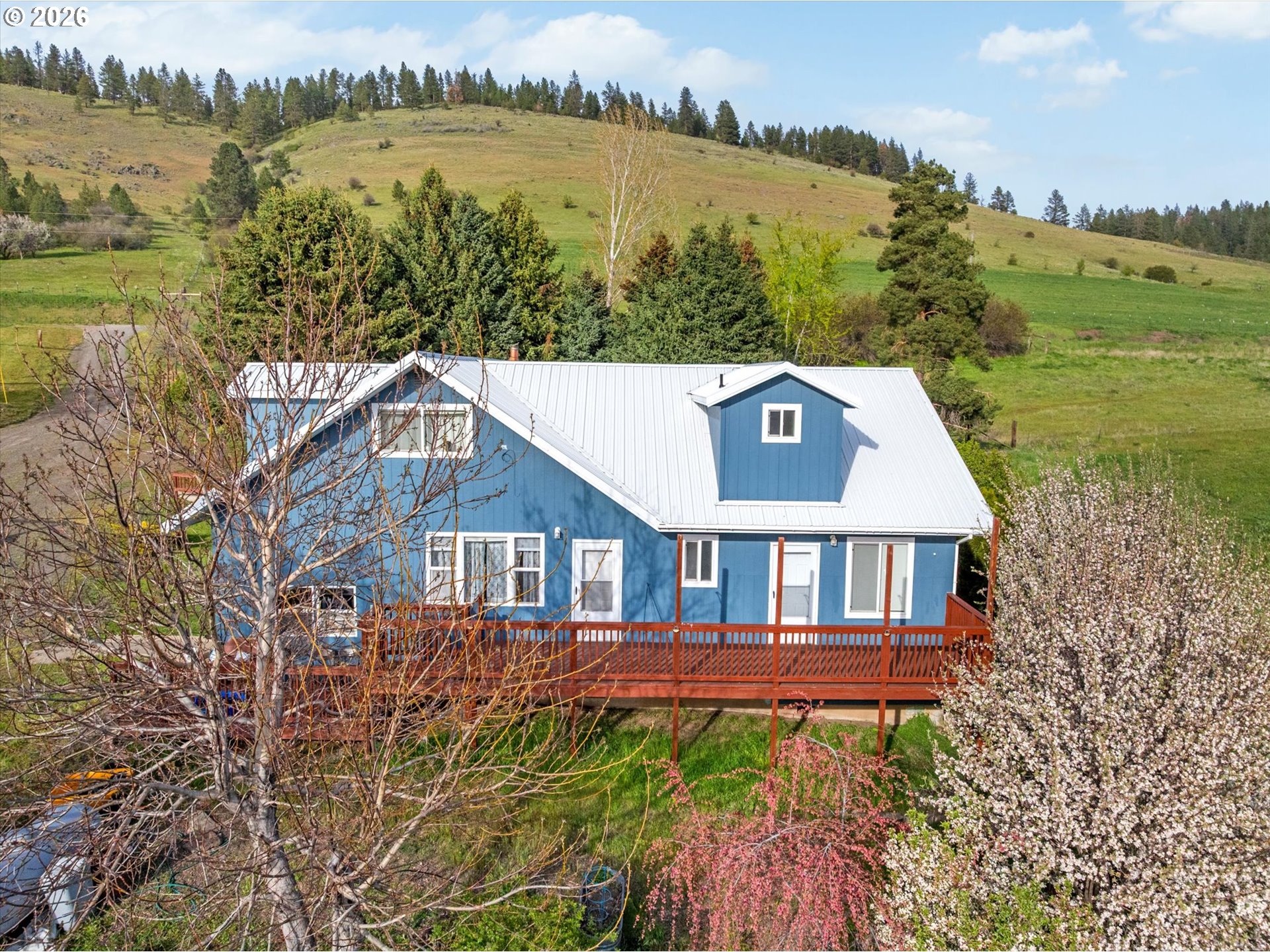 61938 High Valley Road Union, OR 97883 - Photo 22 of 46 a picture of a lake with a house in the background