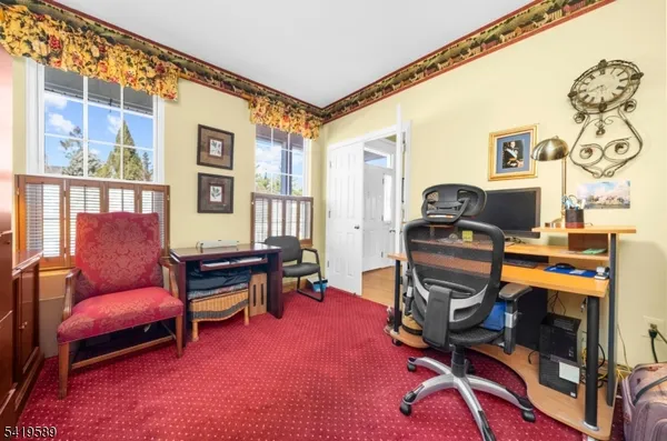 a view of a livingroom with workspace and a window