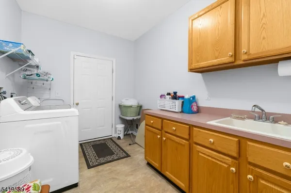 a utility room with sink dryer and washer
