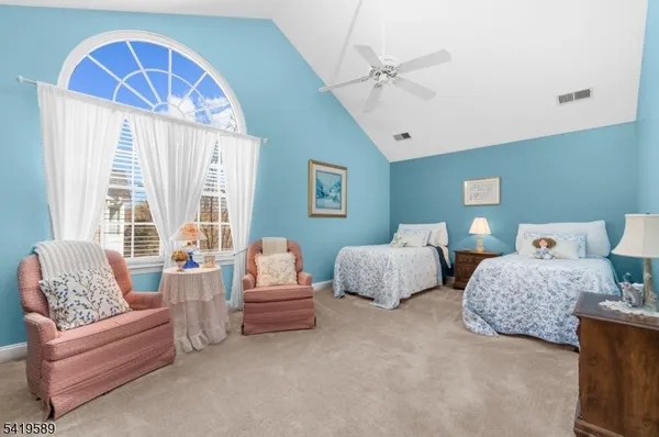 a spacious bedroom with two beds and a large window