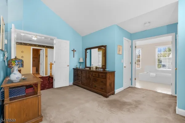 a living room with furniture and a dresser