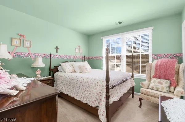 a bed room with a bed and a chair