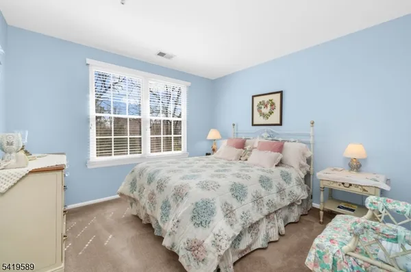 a bedroom with bed and a window