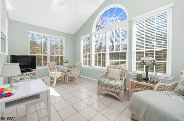 a living room with furniture and large windows