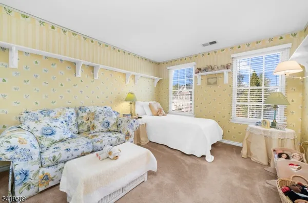 a spacious bedroom with a bed and a couch