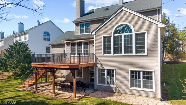a front view of a house with glass windows and furniture