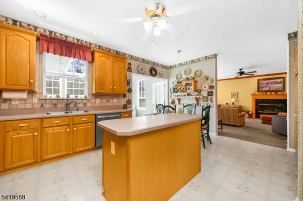 a kitchen with stainless steel appliances granite countertop a sink and cabinets