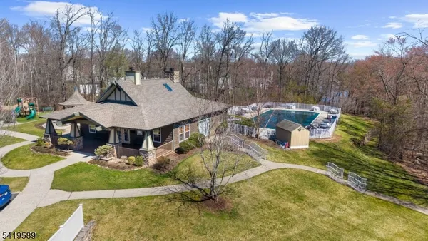 a view of a patio with table and chairs potted plants and large tree