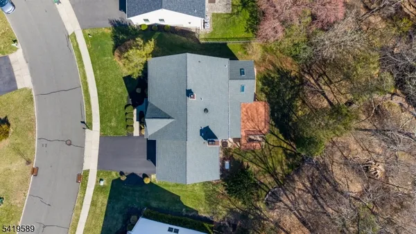 an aerial view of a house with a yard and fountain in front of it