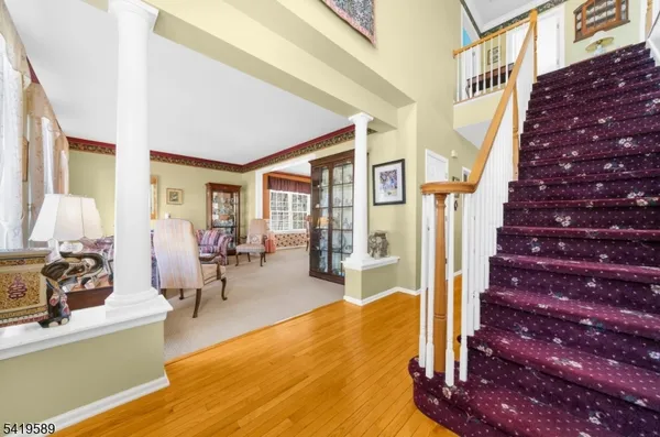 a living room with furniture a dining table and chairs with wooden floor