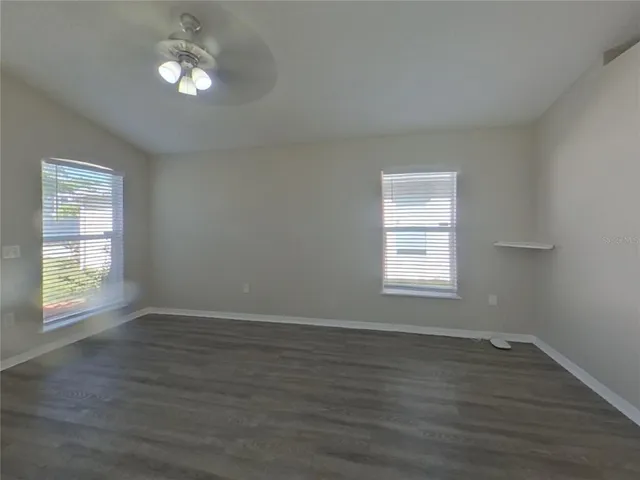 a view of wooden floor and windows in a room
