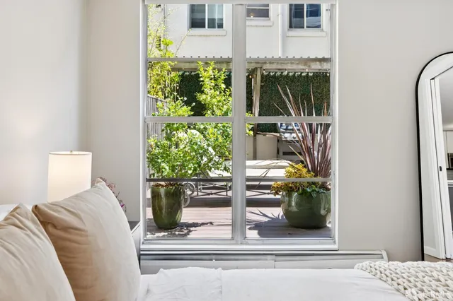a living room with furniture and a potted plant