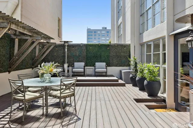 a view of a patio with couches and potted plants