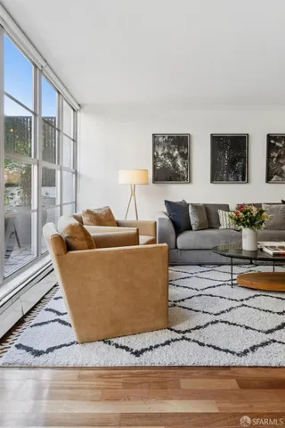 a living room with furniture and a floor to ceiling window