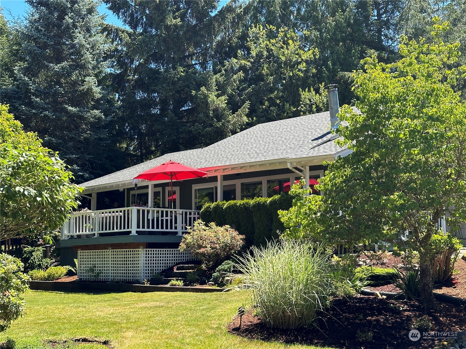 91 East Canyon View Road Belfair, WA 98528 - Photo 1 of 39 a front view of a house with a yard patio and swimming pool