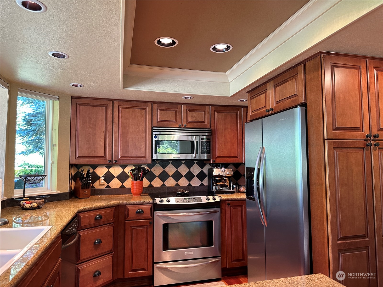 91 East Canyon View Road Belfair, WA 98528 - Photo 17 of 39 a kitchen with stainless steel appliances granite countertop a refrigerator and a sink