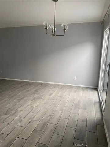 a view of a livingroom with an empty space and a window