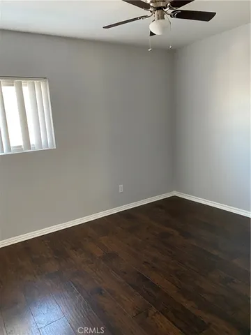 a view of a room with wooden floor and a window