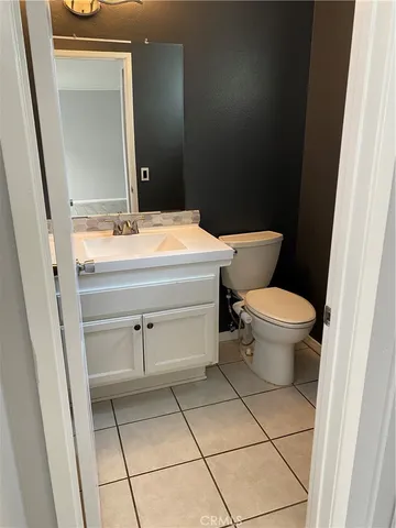 a white toilet sitting next to a shower