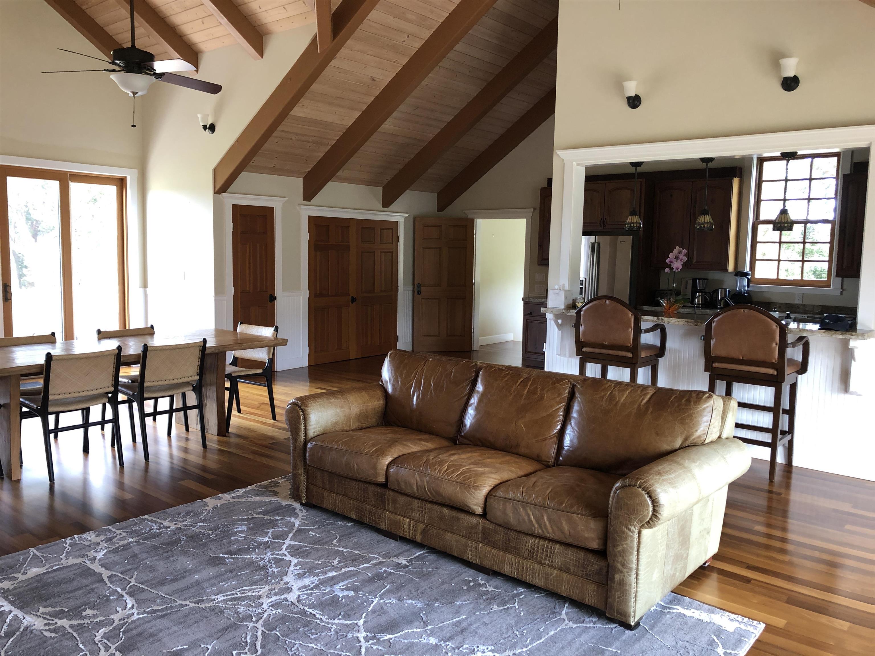 325 Waiahiwi Road Makawao, HI 96768 - Photo 6 of 30 a living room with furniture dining table and a large window