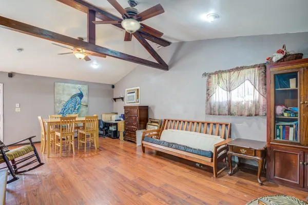 a living room with furniture and a wooden floor
