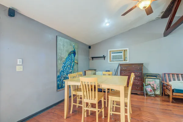 a view of a dining room with furniture and wooden floor
